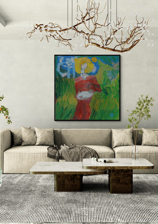 The Woman in the Wheat by António D'Albuquerque in a black frame above a beige sofa under a branch chandelier