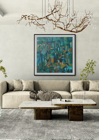 Forest of Figures by António D'Albuquerque in a black frame above a beige sofa under a branch chandelier
