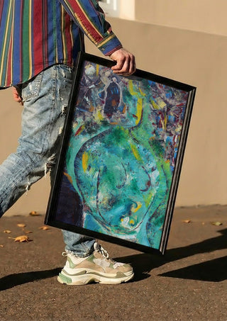 Belly of the Sea by António D'Albuquerque carried in a black frame along a sunny street