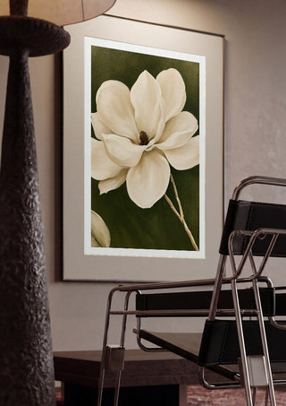 White Magnolia by Martina Karlsson framed in a dim room beside a tubular steel chair