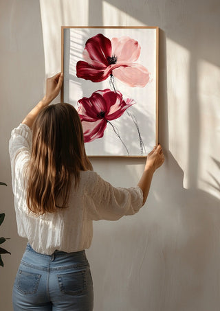 Crimson and Blush by Martina Karlsson being hung on a sunlit wall