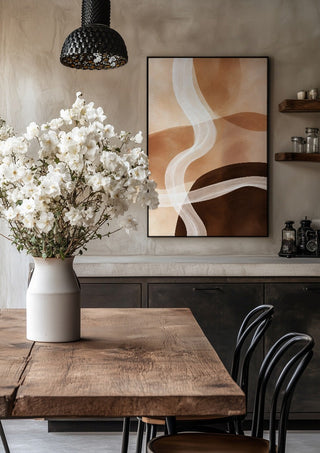 Sand and Clay by Martina Karlsson in a black frame above a rustic table with white flowers