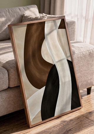 Dune and Shadow by Martina Karlsson in a walnut frame leaning against a grey sofa
