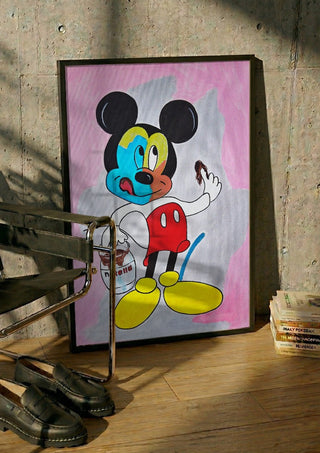 Not by Cheese Alone by NKo in a black frame leaning against a concrete wall by a steel chair