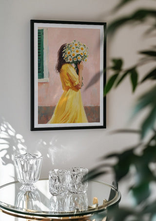Girl in yellow dress with flowers by Ohkimiko in a black frame above a glass table with crystal glassware
