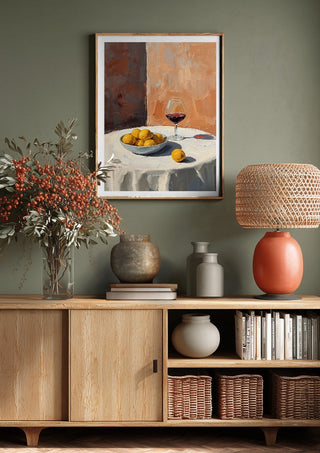 Summer scene: Lemons and wine by Ohkimiko above a wooden sideboard on a sage green wall