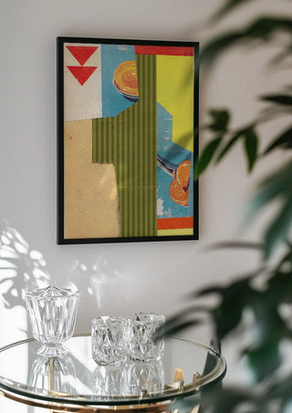 Peach & Mandarin by Kareem Rizk in a black frame above a glass table with crystal glassware