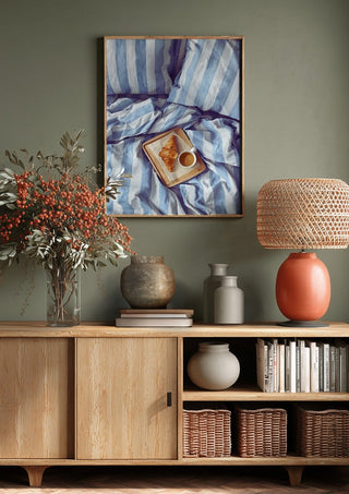 A Cozy Sunday in Bed by Ohkimiko above a wooden sideboard on a sage green wall