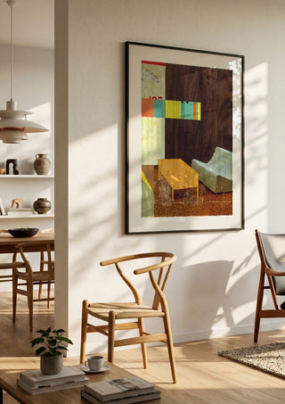 White Sofa by Kareem Rizk in a black frame in a bright dining room with wooden chairs