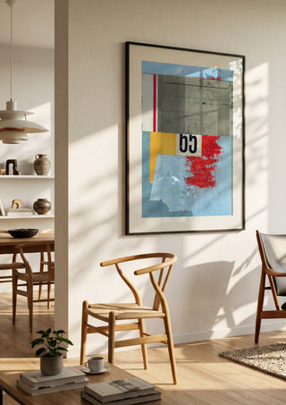 No.65 by Kareem Rizk in a black frame in a bright dining room with wooden chairs