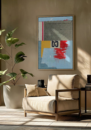 No.65 by Kareem Rizk framed above a beige armchair beside a potted plant