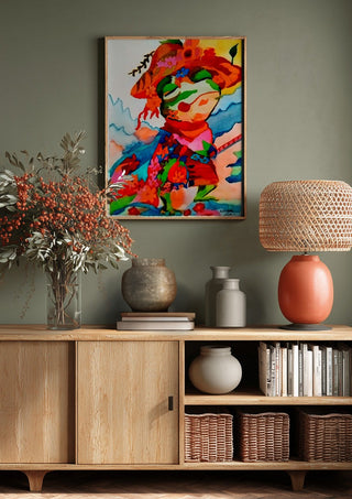 The little frog by Nittaart above a wooden sideboard on a sage green wall