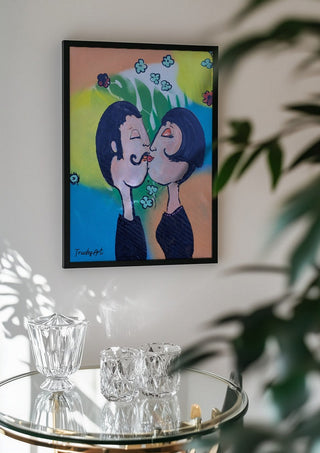 Der Kuss im Glücksregen by Trude in a black frame above a glass table with crystal glassware