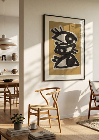 Abstract line art eyes 10 by ThingDesign in a black frame in a bright dining room with wooden chairs