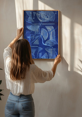 Curved lines / blue field by Linor Citaku being hung on a sunlit wall