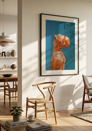 Up by Linor Citaku in a black frame in a bright dining room with wooden chairs