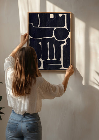 Modern Abstract Minimal Shapes 162 by ThingDesign being hung on a sunlit wall