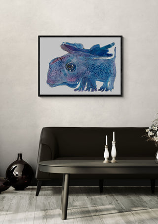 The Blue Watcher by Lena Galé in a black frame above a dark sofa with candlesticks on a round table