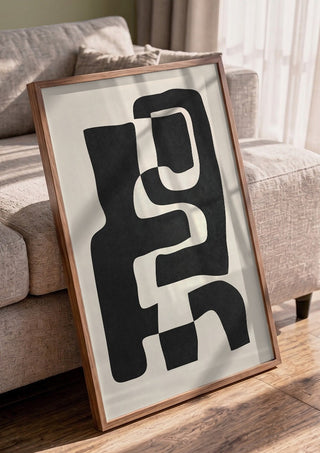 Abstract Art 55 by ThingDesign in a walnut frame leaning against a grey sofa