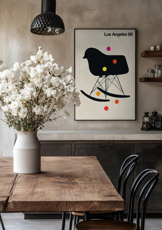 Los Angeles 69 by Bo Lundberg in a black frame above a rustic table with white flowers