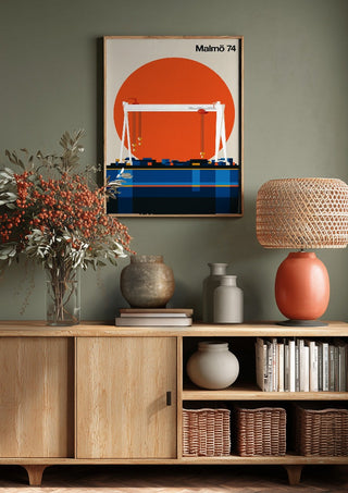 Malmö 74 by Bo Lundberg above a wooden sideboard on a sage green wall