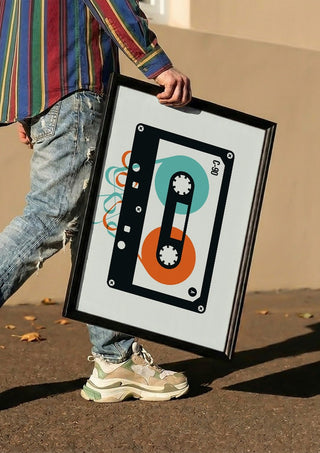 Mixtape by Bo Lundberg carried in a black frame along a sunny street