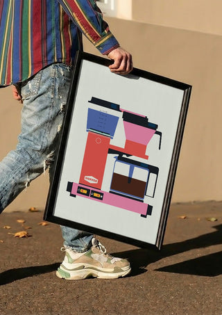 Pastel coffee by Bo Lundberg carried in a black frame along a sunny street