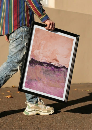 expressive landscape by Iris Lehnhardt carried in a black frame along a sunny street