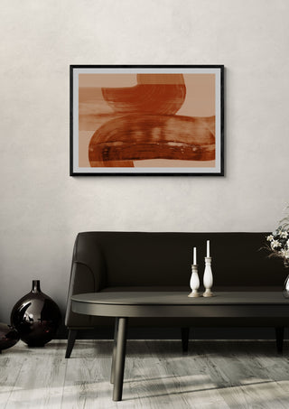 abstract shapes - autumn orange by Iris Lehnhardt in a black frame above a dark sofa with candlesticks on a round table