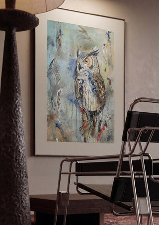 Owl by Lüba framed in a dim room beside a tubular steel chair