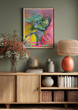 Strange Wanderer by Lena Galé above a wooden sideboard on a sage green wall