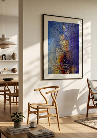 Ships in Violet and Gold by Justyna Kopania in a black frame in a bright dining room with wooden chairs