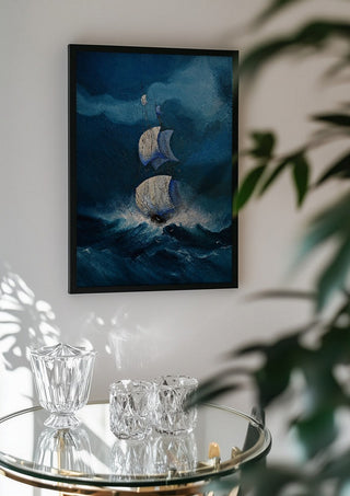 Sails in the Dark Swell by Justyna Kopania in a black frame above a glass table with crystal glassware