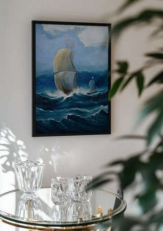 Full Sail by Justyna Kopania in a black frame above a glass table with crystal glassware