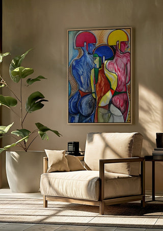 The 3 Graces by inksideme framed above a beige armchair beside a potted plant
