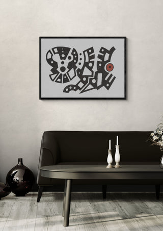 Black and White Glyphs by John Larkin in a black frame above a dark sofa with candlesticks on a round table
