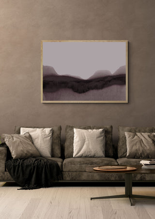 abstract moody landscape by Iris Lehnhardt in a light oak frame above a grey sofa on a warm brown wall
