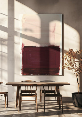 colorfields pale pink warm red by Iris Lehnhardt hanging above a wooden dining table in warm sunlight
