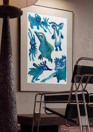 Creatures by Lena Galé framed in a dim room beside a tubular steel chair
