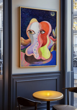 Two Faces Under the Moon by Shimmering Ugly in an oak frame on a panelled cafe wall