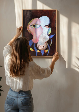 Two Eyes, One Head by Shimmering Ugly being hung on a sunlit wall