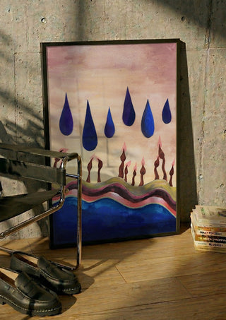 Candles Under Blue Drops by Shimmering Ugly in a black frame leaning against a concrete wall by a steel chair