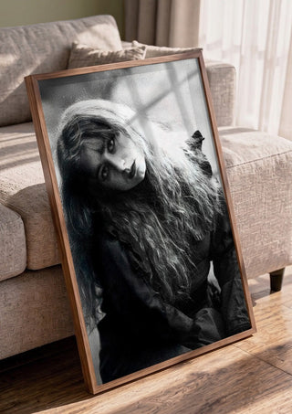 Wind in Her Hair by Bettinafloorphoto in a walnut frame leaning against a grey sofa