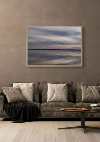 Dusk Reflections by Bora Kőhalmi in a light oak frame on a warm grey wall above a brown sofa