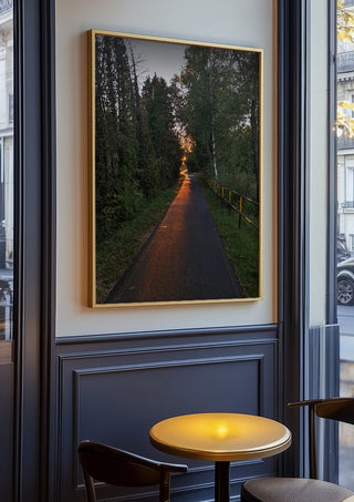 The Amber Forest Path by Bora Kőhalmi in an oak frame on a panelled café wall