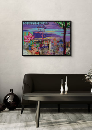 The sun sets to risa again by María Burgaz in a black frame on a pale wall above a dark sofa with candlesticks