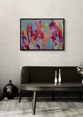 Warmth by Janet Bell in a black frame on a pale wall above a dark sofa with candlesticks