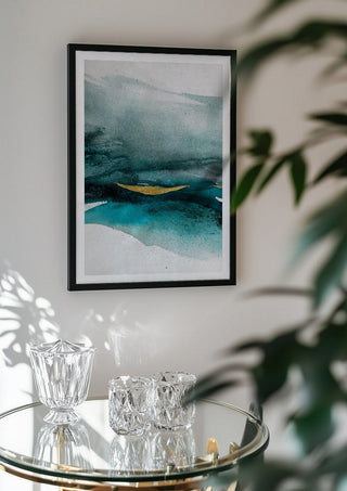 Emerald paradise by Tania Zubareva in a black frame above a glass table with crystal glassware