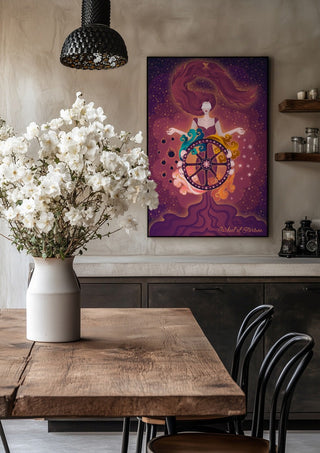 Wheel of Fortune by Sciurus tarotus in a black frame above a rustic table with white flowers