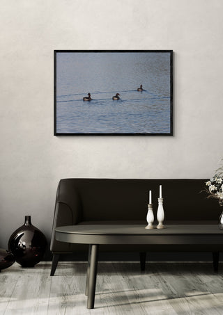 I det fria by Ljilja Marinic in a black frame on a pale wall above a dark sofa with candlesticks